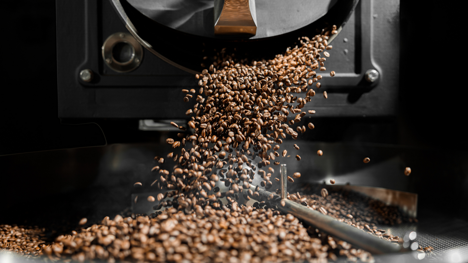 Coffee beans being expelled from a coffee grinder, corporate coffee gift